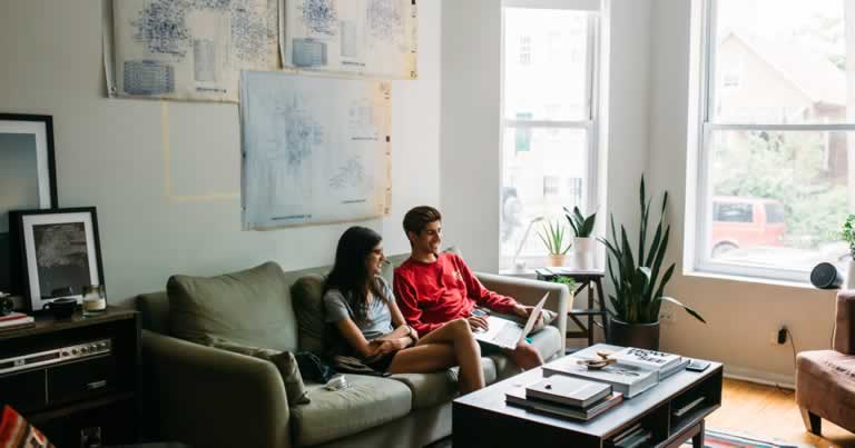 Couple on a Couch Viewing Property Listings